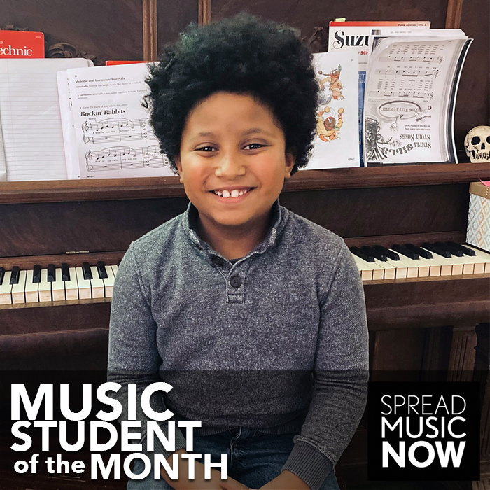 Avery in front of piano